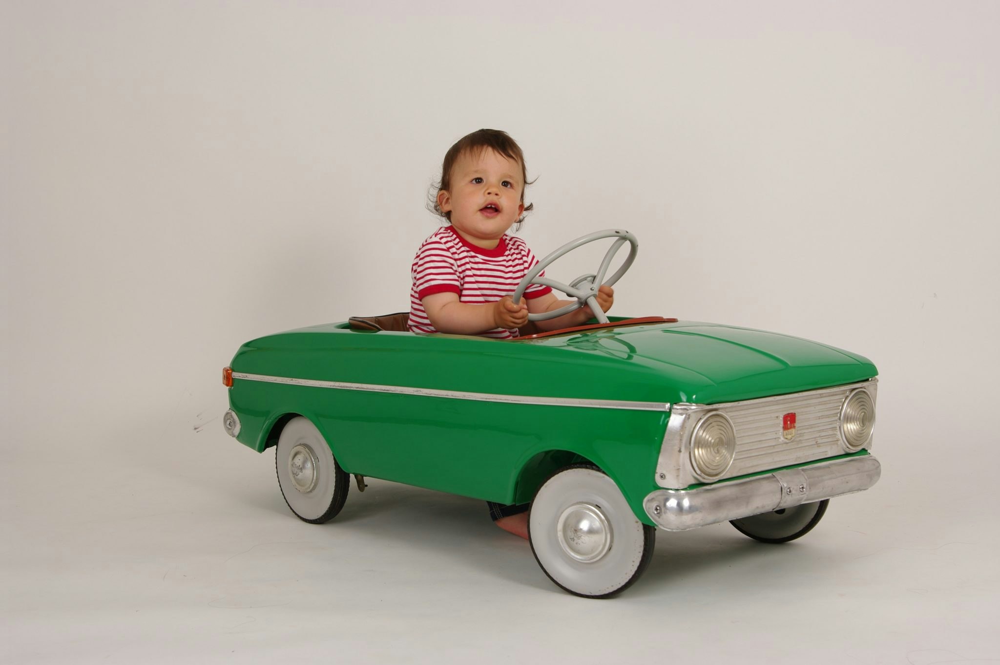 Child in a retro toy car