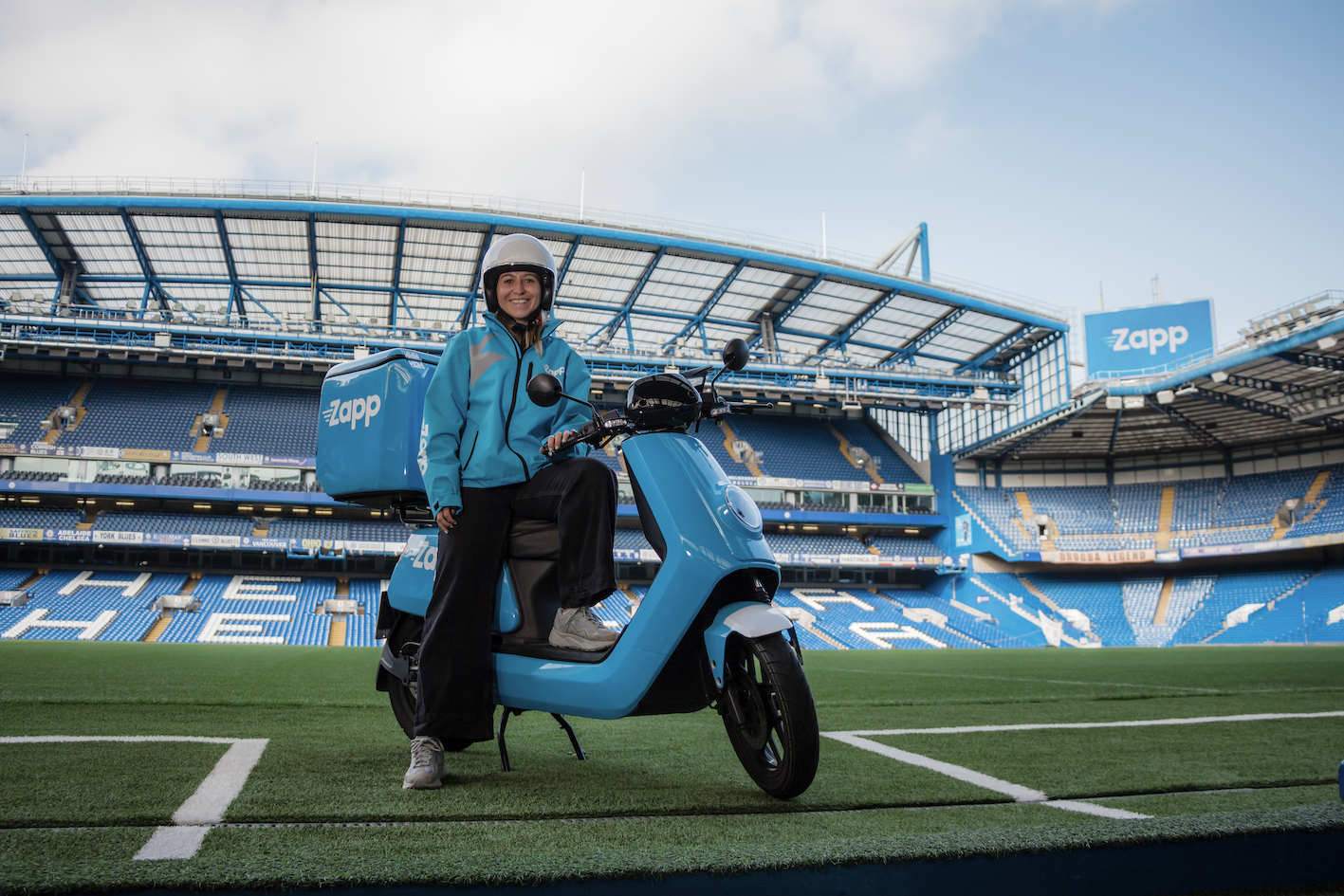 Zapp delivery driver sits on moped in Stamford Bridge